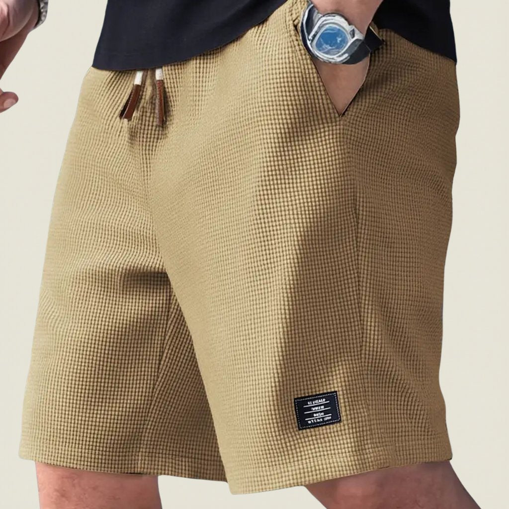 Man modeling comfortable relaxed fit lightweight shorts, ideal for summer daily essentials & outdoor style.