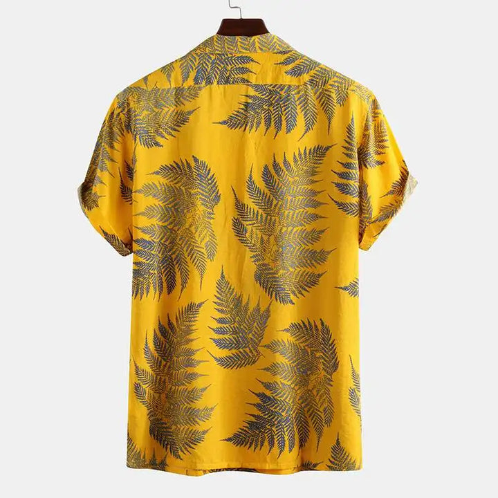 Close-up of men's short sleeve tropical button-up shirt featuring a vibrant, unique summer print.
