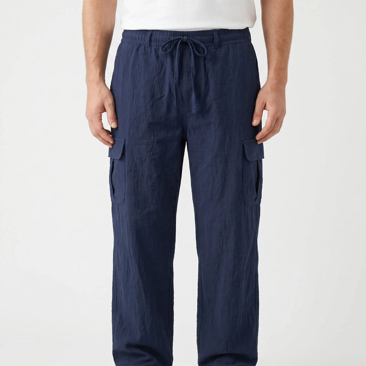 Khaki men's cargo pants with multiple utility pockets, ideal for travel and summer comfort.