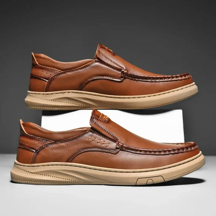 Elegant black leather slip-on loafers for men. Madison design for sophisticated, easy-wear style.