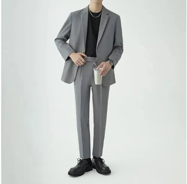 Sharp tailored men's two-piece suit, embodying modern minimalist style for formal & business wear.