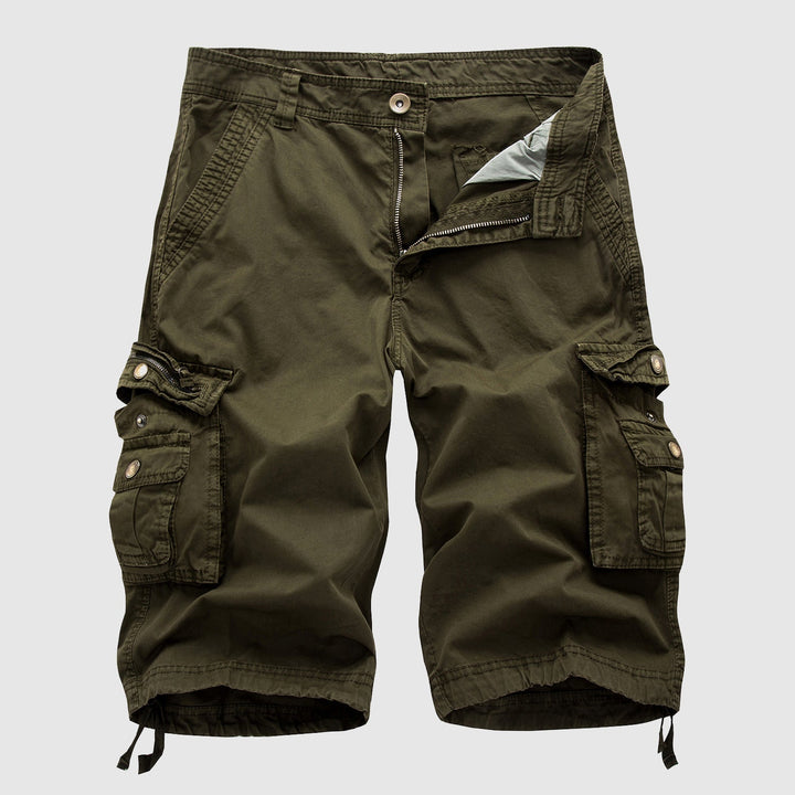Man wearing versatile men's multi-pocket cargo shorts, enjoying outdoor activities with a relaxed fit.