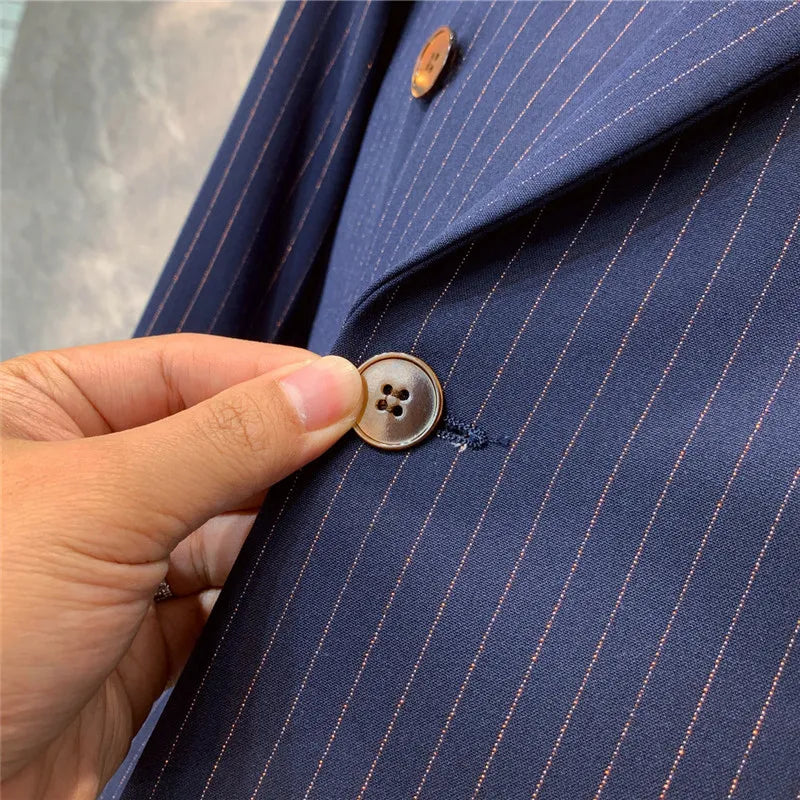 Stylish men's tailored navy pinstripe double-breasted suit, ideal for formal business and elegant evening wear.