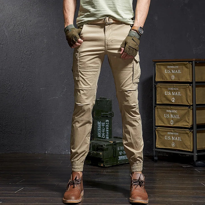 Rugged Outland men's tactical cargo pants with tapered leg & cuffed ankle. Durable outdoor & streetwear bottoms.