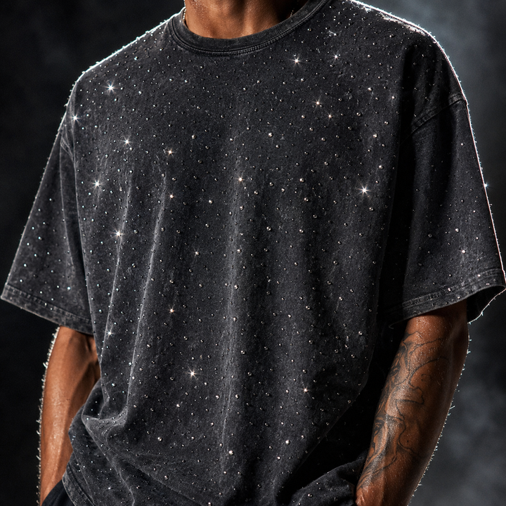 Close-up of sparkling rhinestone detail on a comfortable men's oversized crewneck t-shirt.