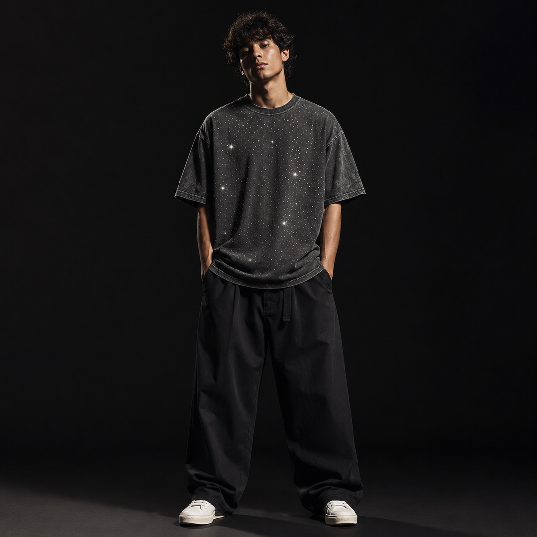 Model wearing a relaxed men's oversized rhinestone t-shirt, ideal for spring & summer streetwear.
