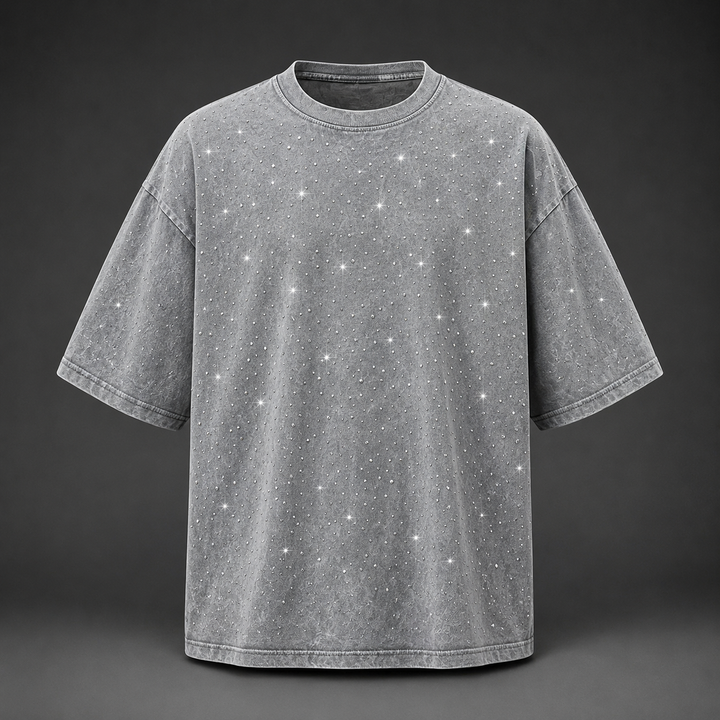 Detailed shot of the soft washed fabric and shimmering rhinestones on a men's casual t-shirt.