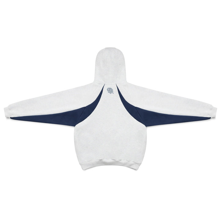 Man wearing oversized pullover hoodie with sporty contrast panels. Dynamic men's fashion, active streetwear style.