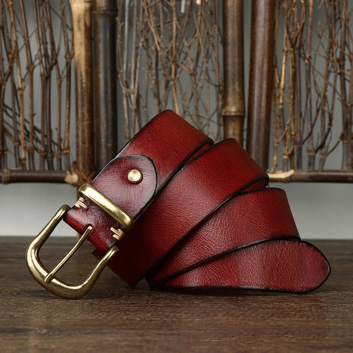 Stylish men's handcrafted full-grain leather belt paired with formal trousers.