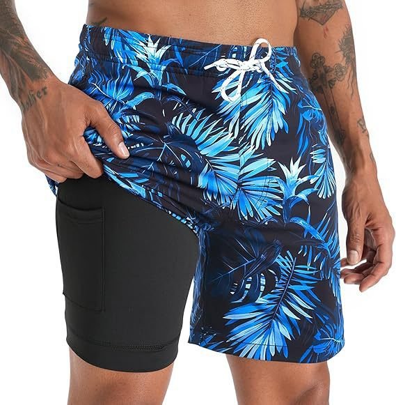 Man wearing quick-dry swimwear shorts with compression liner, ready for swimming, beach, or active sports.