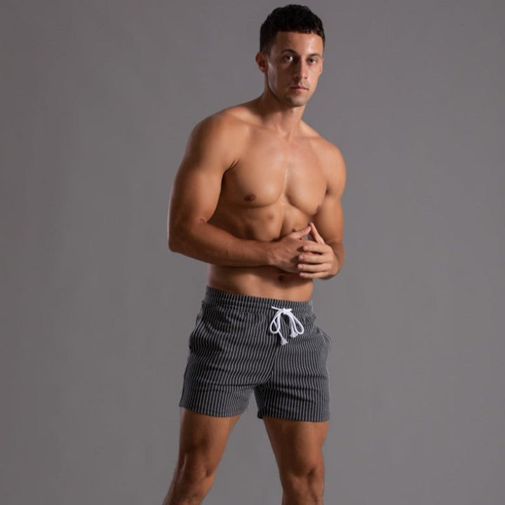 Stylish men's quick-dry swim trunks, ripstop polyester for elevated beach fashion.