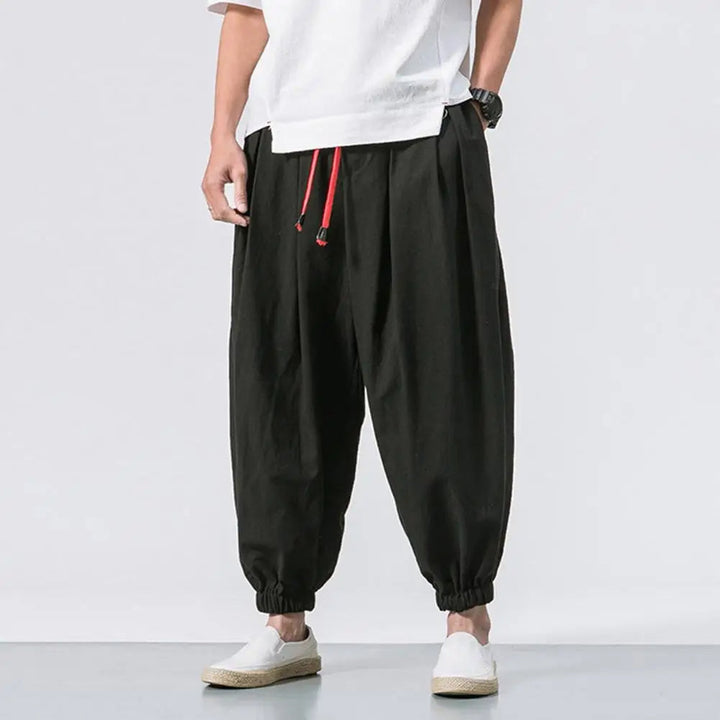 Close-up of soft fabric on men's relaxed fit baggy harem jogger pants, highlighting comfortable material.