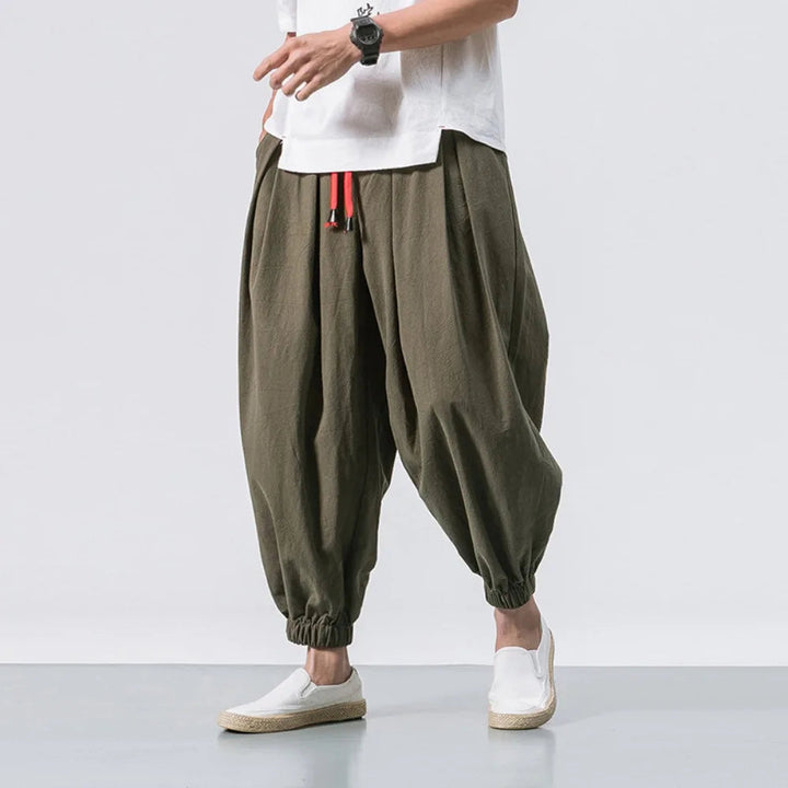 Man walking in relaxed fit baggy harem jogger pants, showcasing freedom of movement & casual style.