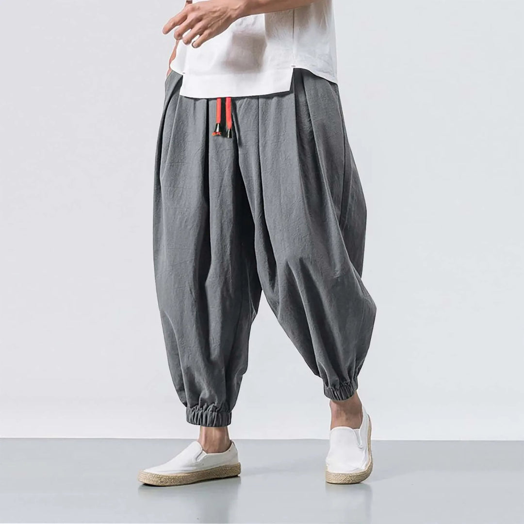 Front view of men's relaxed fit baggy harem jogger pants, featuring adjustable waist & roomy fit.