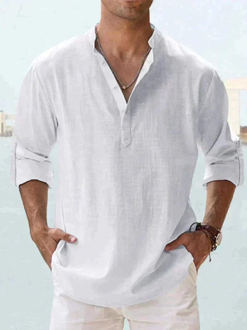 Man wearing a relaxed fit long-sleeve button-down summer shirt, ideal for a casual, warm weather look.