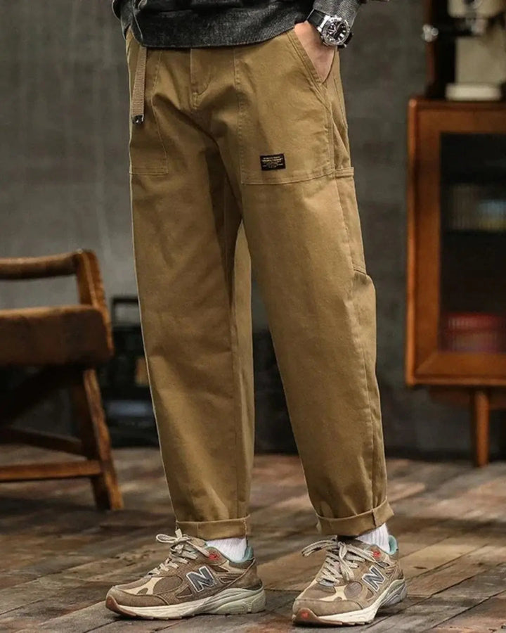 Man wearing relaxed fit multi-pocket cargo pants, ideal for comfortable outdoor casual wear.
