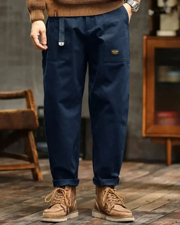 Khaki men's relaxed fit cargo pants with large side pockets, essential for practical everyday style.