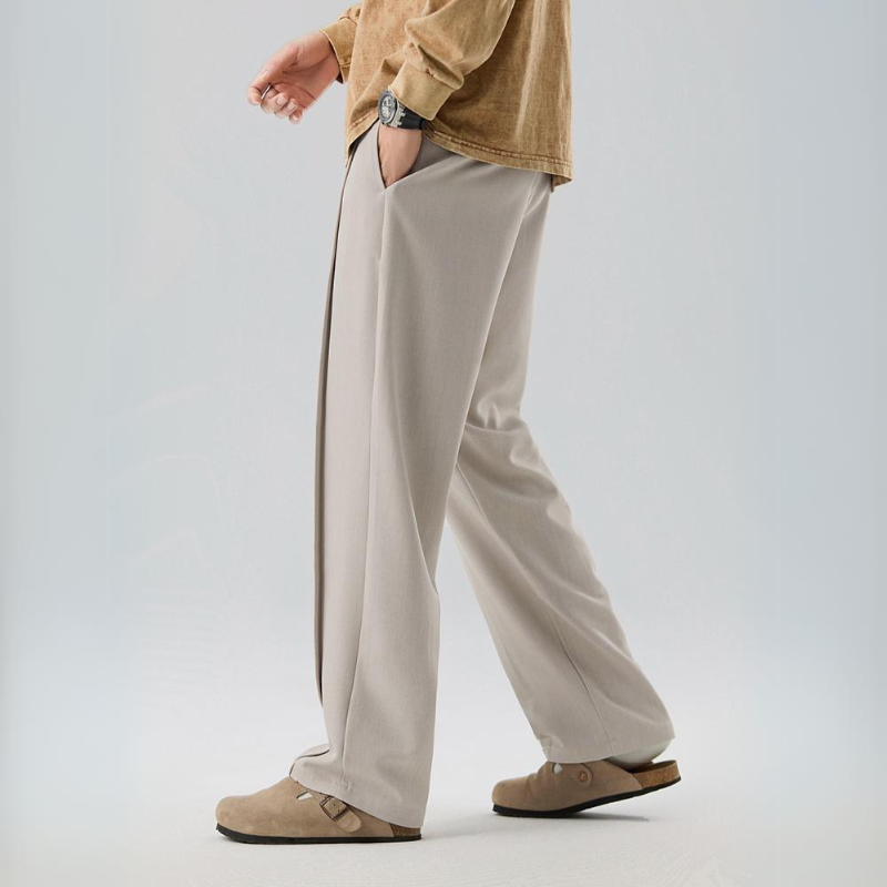 Relaxed fit men's pleated dress pants, comfortable & versatile for formal events or casual outings.