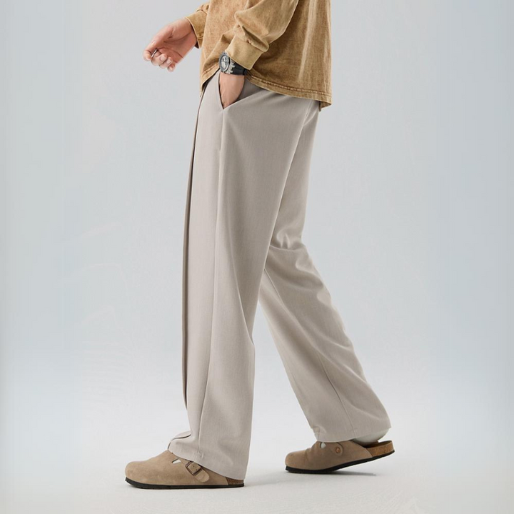 Relaxed fit men's pleated dress pants, comfortable & versatile for formal events or casual outings.