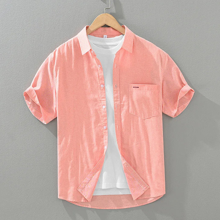 Man wearing a stylish short sleeve men's summer shirt, suitable for warm weather, casual, and smart casual occasions.