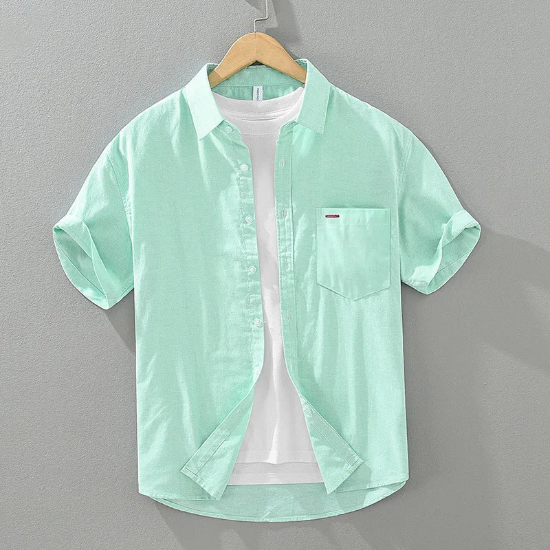 Textured fabric of a relaxed fit men's summer shirt. Short sleeve, versatile, warm weather, and casual men's fashion.