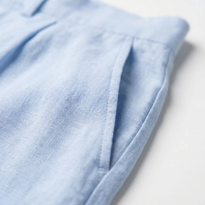 Men's relaxed straight leg pleated trousers styled for smart casual. Versatile, comfortable mid-rise pants for everyday wear.