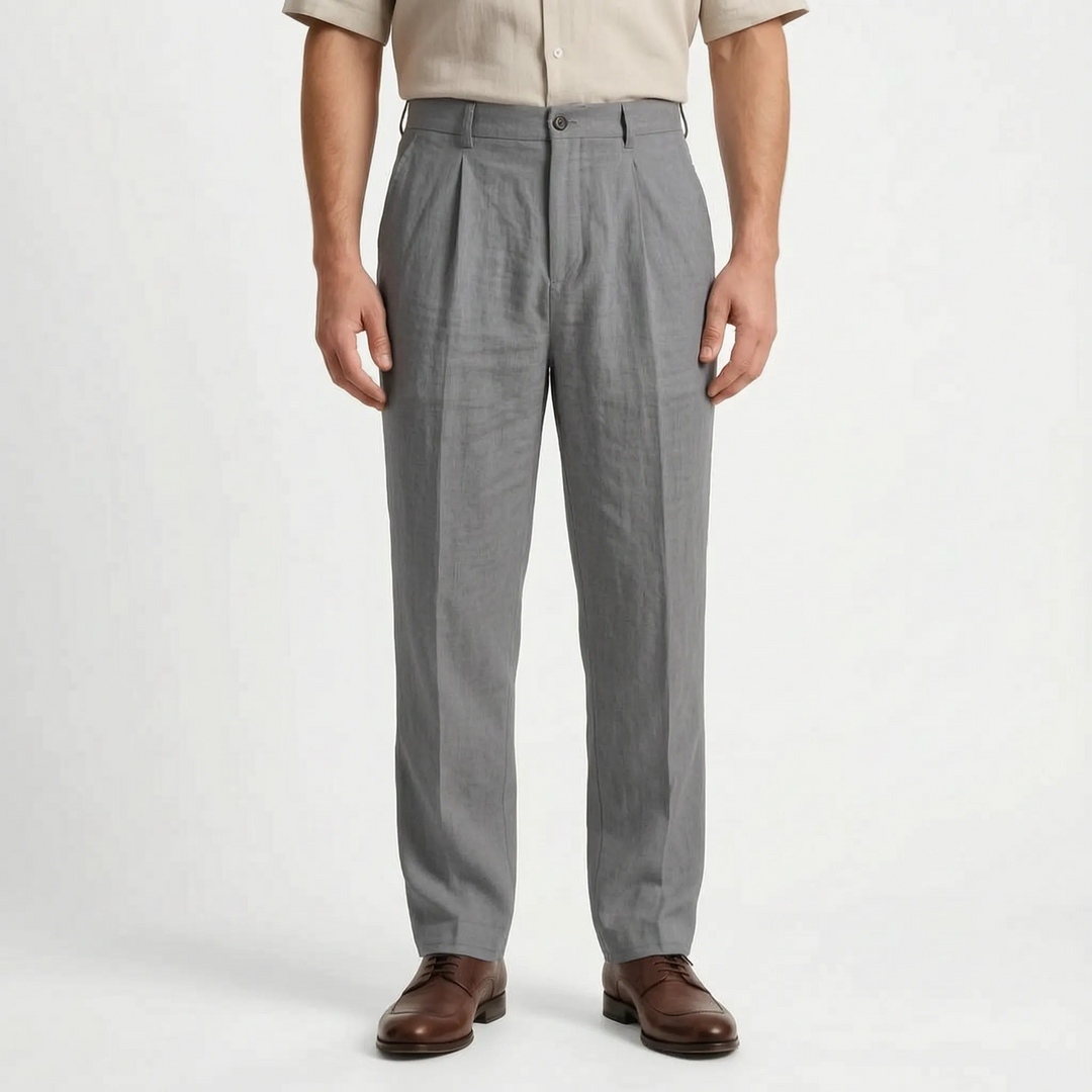Model wearing men's relaxed fit straight leg pleated trousers. Comfortable, versatile mid-rise pants for smart casual style.