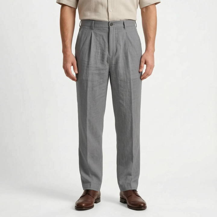 Model wearing men's relaxed fit straight leg pleated trousers. Comfortable, versatile mid-rise pants for smart casual style.