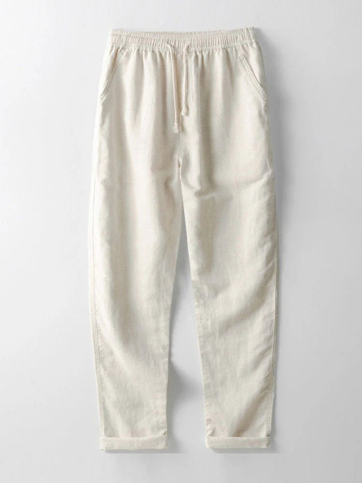 Effortless men's summer style: a two-piece set with a rolled cuff shirt and relaxed fit pants.