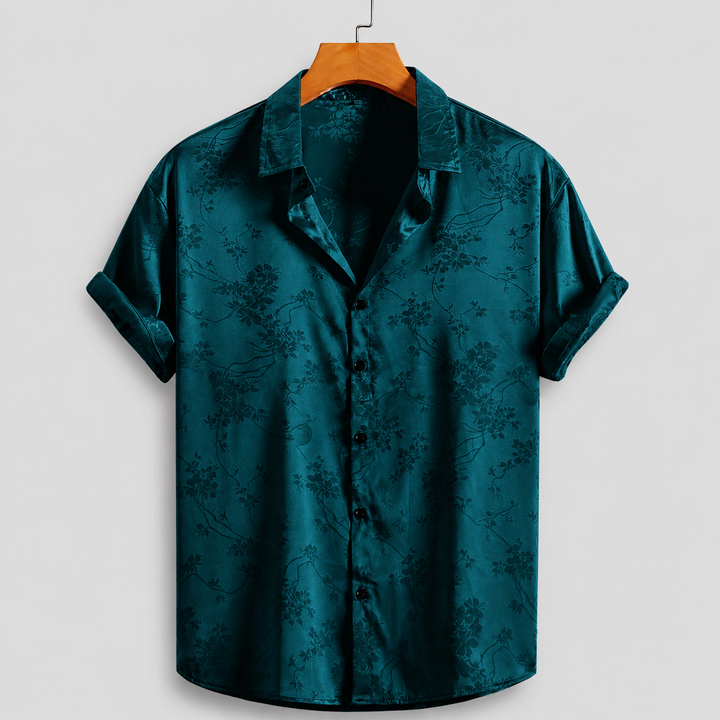 Breathable men's polo shirt featuring a vibrant floral satin print. Comfortable short sleeve summer top.