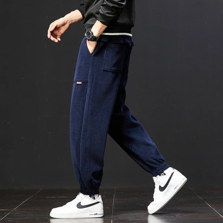 Man wearing relaxed fit men's signature joggers, showcasing comfortable everyday fashion.