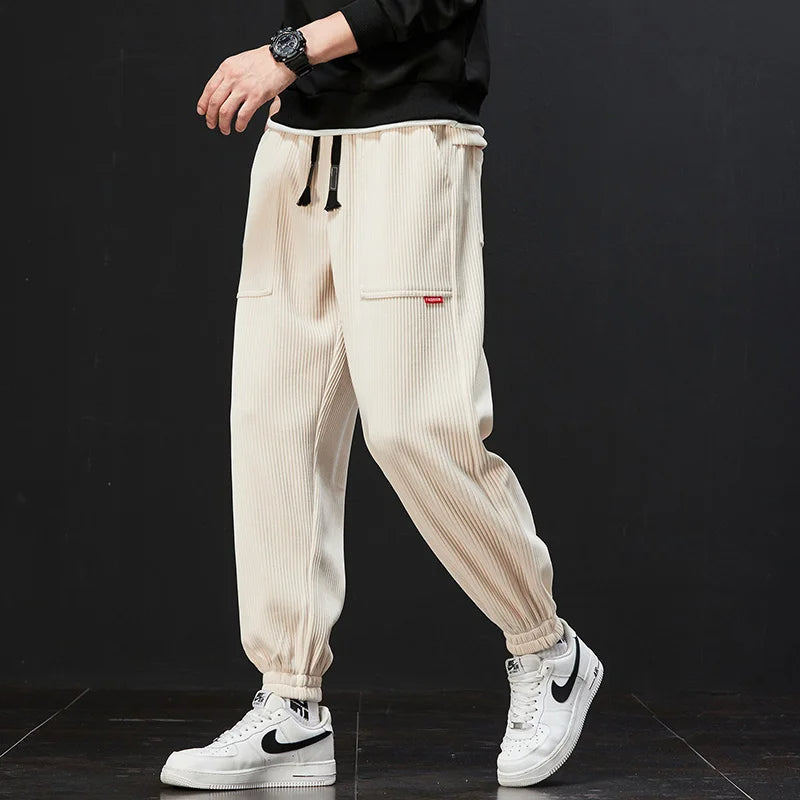 Grey men's signature jogger pants, versatile for athletic, casual, or loungewear, modern style.