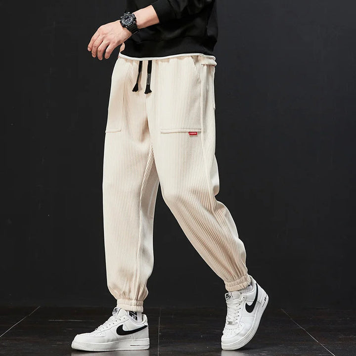 Grey men's signature jogger pants, versatile for athletic, casual, or loungewear, modern style.