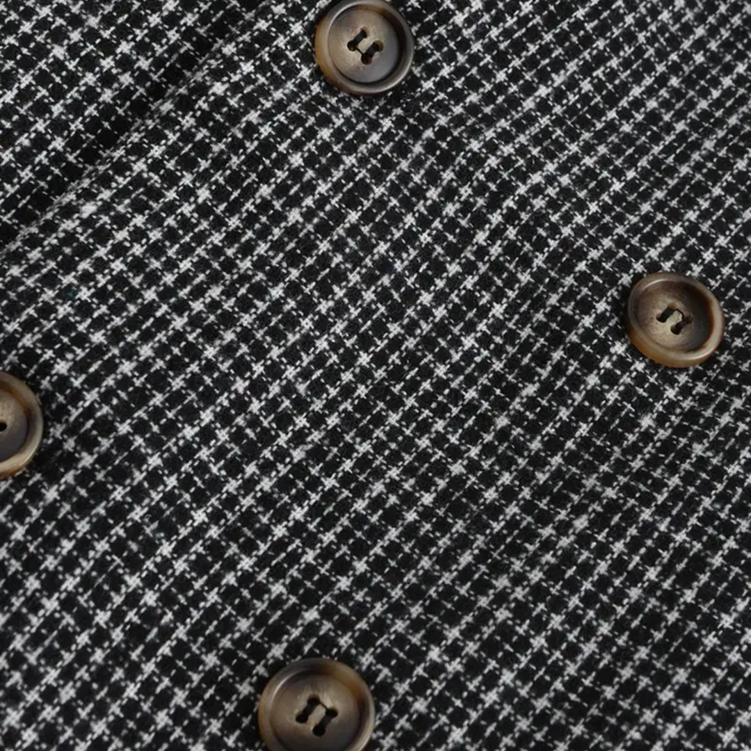 Close-up of men's slim fit check blazer fabric, showcasing the detailed pattern & tailored quality.