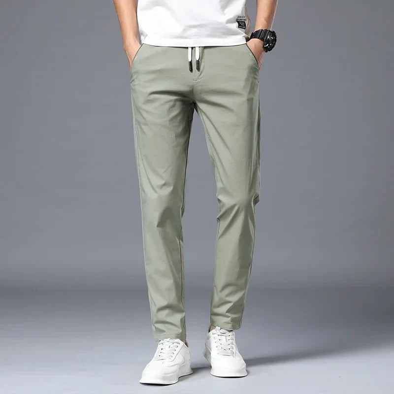 Wrinkle-resistant men's pants with a comfortable slim fit & practical drawstring waist.
