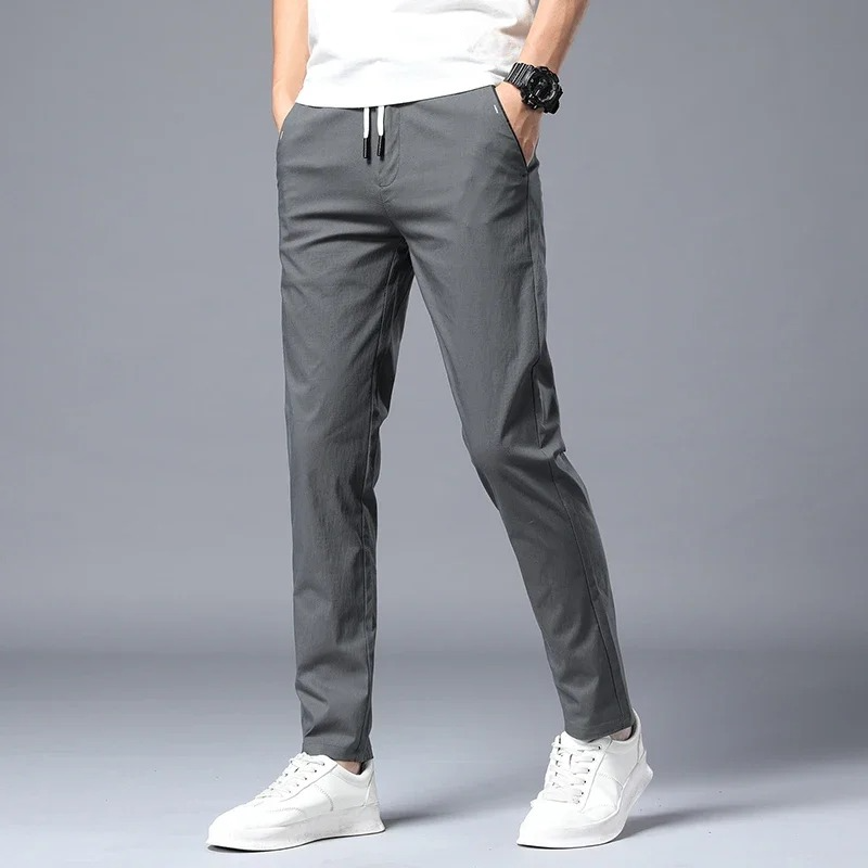 Man wearing dark slim fit comfort pants, showcasing tailored look & relaxed fit.