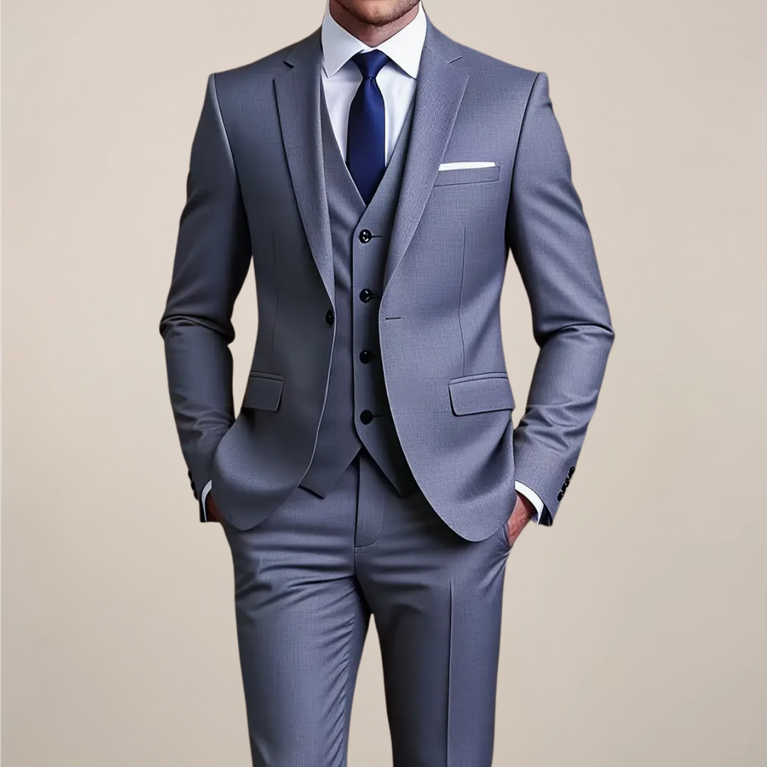 Men's slim fit grey three-piece suit. Perfect for weddings, formal occasions, or business wear. Tailored tuxedo style.