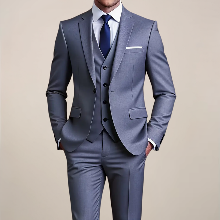 Men's slim fit grey three-piece suit. Perfect for weddings, formal occasions, or business wear. Tailored tuxedo style.