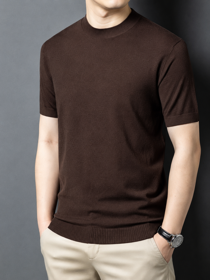 Model wearing a men's slim fit short sleeve mock neck t-shirt, showcasing modern style.