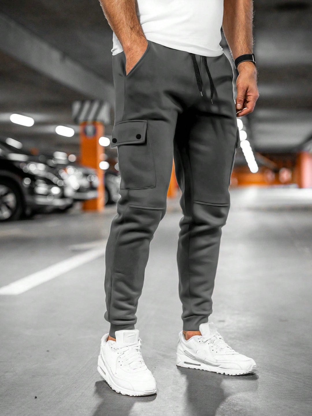 Sporty men's slim-fit drawstring jogger pants with cargo pocket for modern streetwear style.