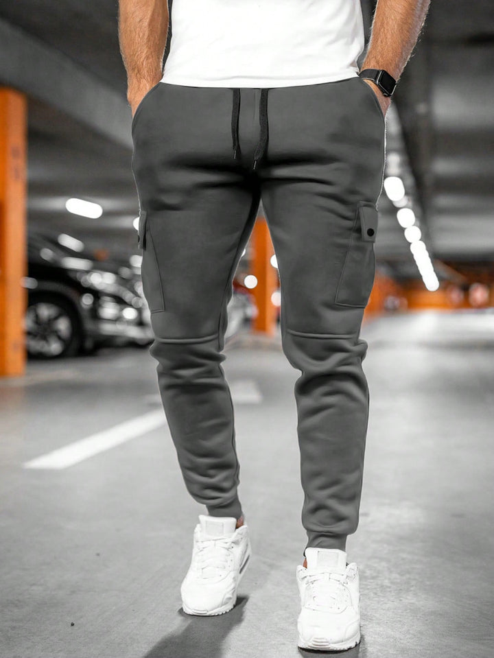 Black tapered fit men's joggers, cargo pocket, ideal for casual and urban wear.