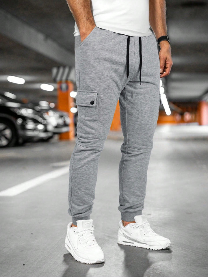 Urban men's tapered fit joggers with cargo pocket, essential for a modern streetwear outfit.