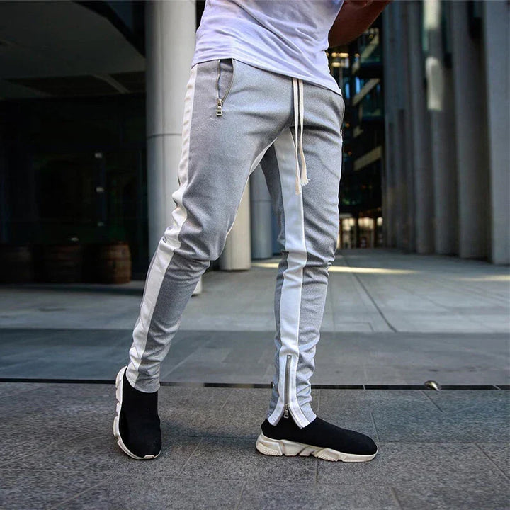 Men's slim fit black track sweatpants with zipper hems, ideal for athletic wear or casual sporty style.