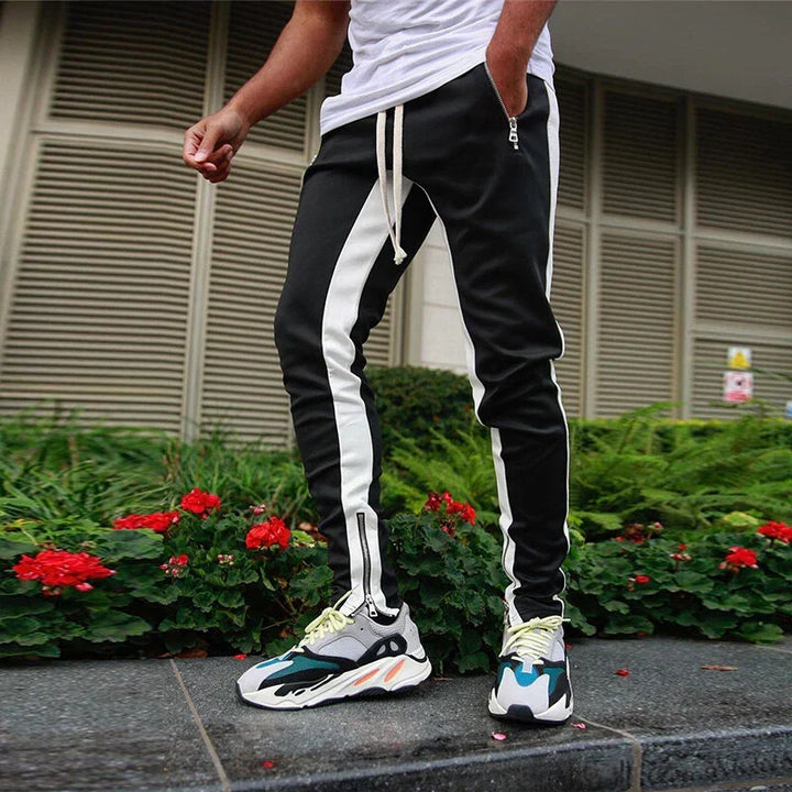Comfortable men's slim fit joggers, grey, with stylish zipper hems, perfect for activewear & casual fashion.