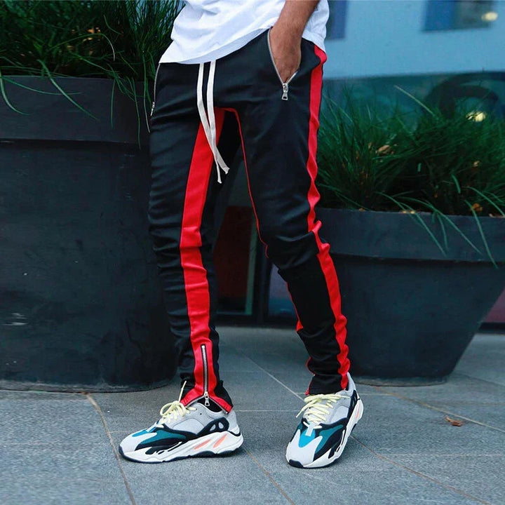 Sporty men's slim fit track pants in navy, featuring practical zipper hems for gym or everyday casual wear.