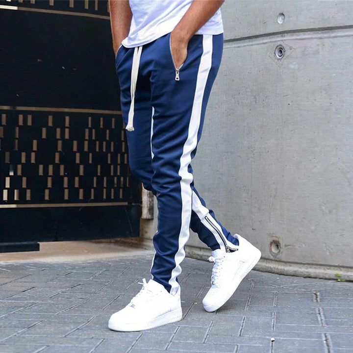 Modern men's slim fit sweatpants, dark grey, with zipper hems; excellent for jogging, sports, or lounge wear.