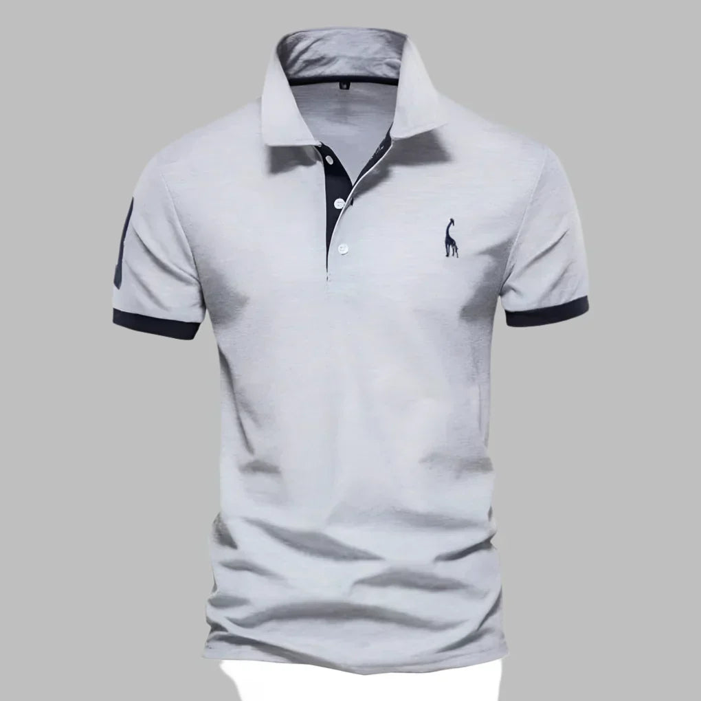 Close-up of men's short sleeve polo shirt, highlighting the smart contrast trim on the collar and placket.