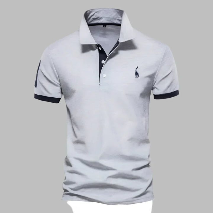 Close-up of men's short sleeve polo shirt, highlighting the smart contrast trim on the collar and placket.