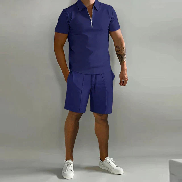 Coordinated men's summer outfit featuring a modern polo shirt with zipper collar and lightweight shorts.