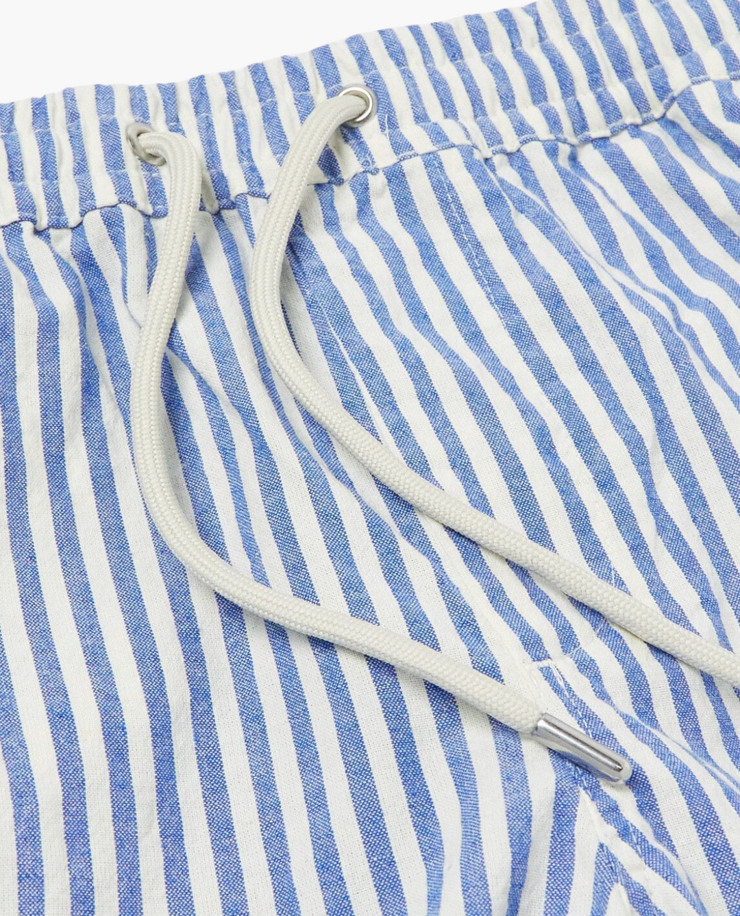Close-up of men's striped summer shorts showing pattern, elastic waist, and relaxed, breathable design.